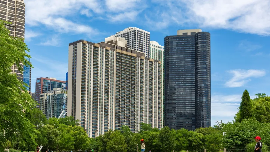 Chicago, Illinois, USA. -July 1, 2024: Sunny day, downtown Chicago street view. Maggie Daley Park, green grassland, overlooking the high-rise buildings.