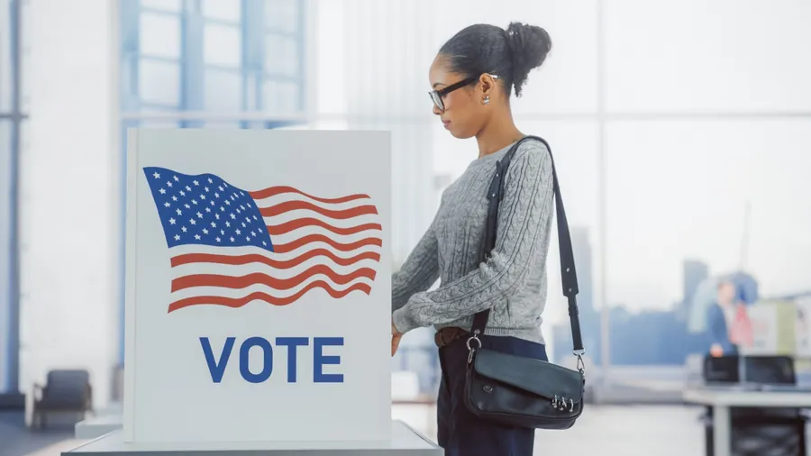 American People on the Election Day in the United States of America. Diverse People Using Voting Booths to Give Their Vote to a Preferred Candidate. Beautiful Black Female Filling Out Her Ballot