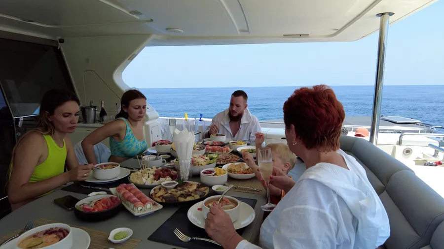 Phuket, Thailand, 30,September, 2023: Family lunch on private luxury yacht, tourists having lunch on yacht while island hopping