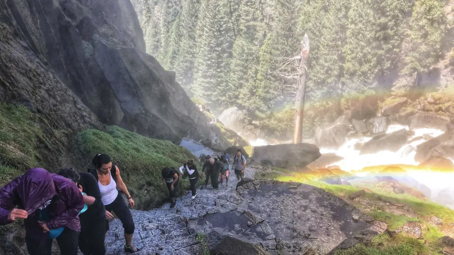 YOSEMITE, CA, USA - MAY 2, 2018: Tourist climbing mist trail to the top of Vernal falls in the national park
