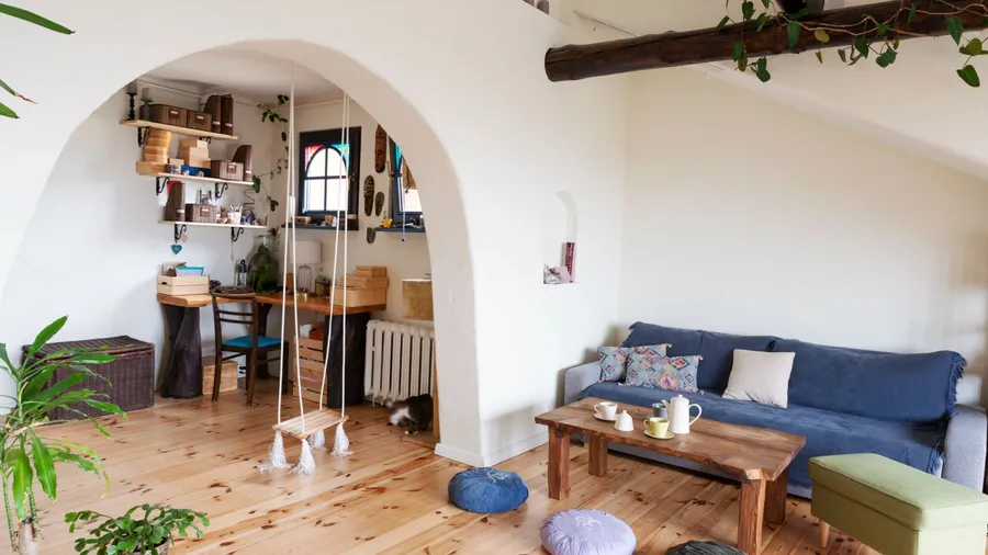 Cozy living room with a blue sofa, wooden table, and decorative pillows.