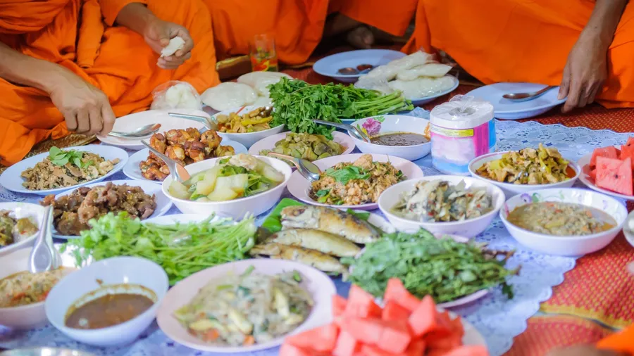 Food offerings to the Buddha, merit raising in Thailand.
