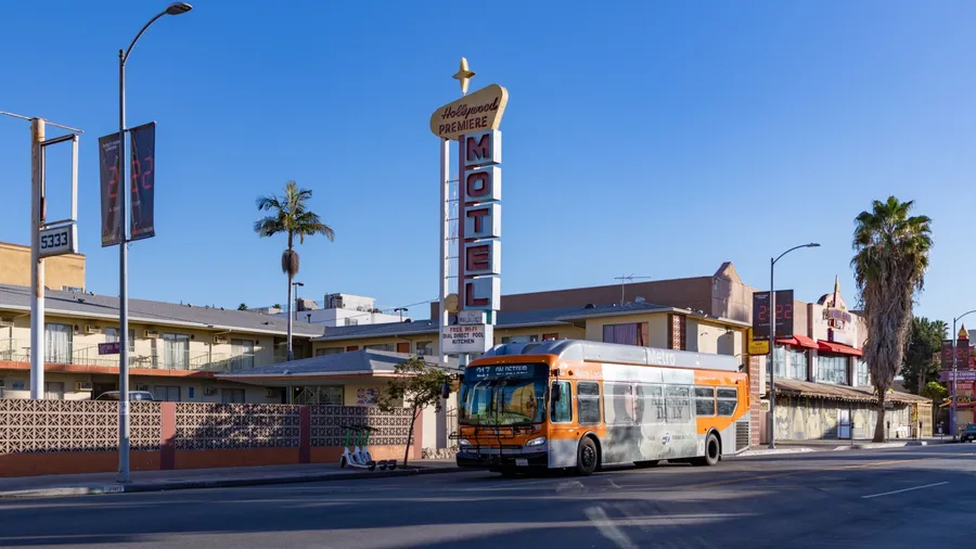 Los Angeles, United States - November, 2022: A picture of a Metro bus parked in front of a hotel in Los Angeles.