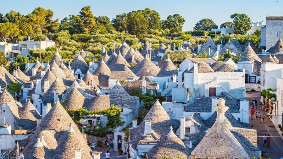 Puglia, Italy - Jul 2018: Trulli of Alberobello, UNESCO heritage. The trulli, typical limestone houses of Alberobello in the south of Puglia, are extraordinary examples of dry stone slabs.