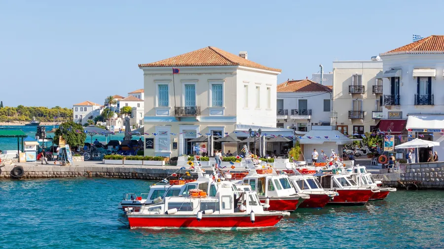 SPETSES, GREECE - 09.09.2023: Sea taxis at the small port of Dapia, in Spetses island, Greece, on the day of the Armata, the most popular local festival.