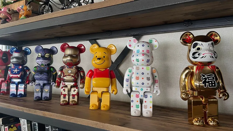A shelf featuring collectible Bearbrick figures in various designs, including characters from pop culture.