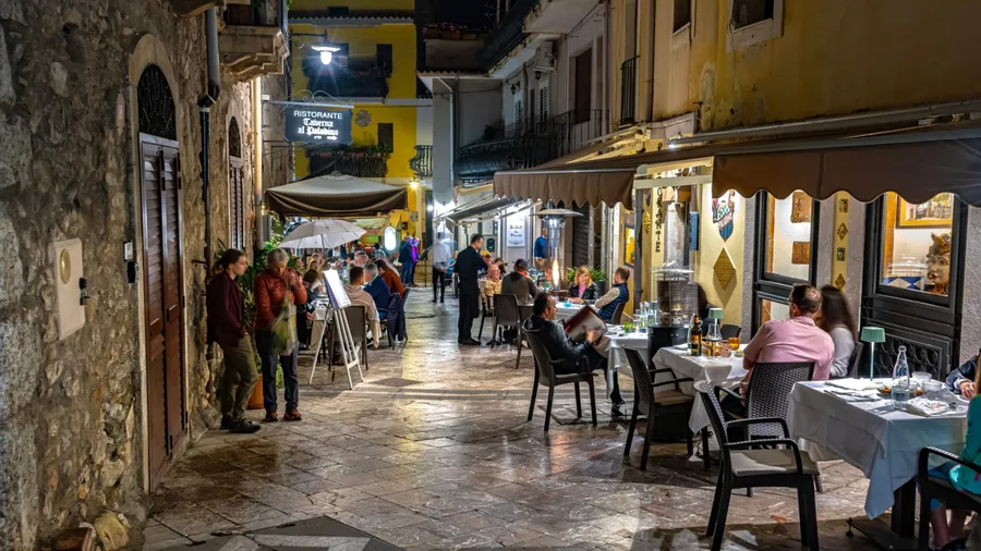 TAORMINA, ITA - MAY 25, 2023: Restaurants in Taormina, in the Metropolitan City of Messina, on the east coast of Sicily, Italy, in the night