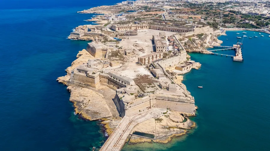 Fort Ricasoli aerial view. Island of Malta from above. Bastioned fort built by the Order of Saint John in Kalkara, Malta. Gallows' Point, north shore of Rinella Bay, entrance to the Grand Harbour.