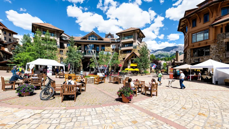 Telluride, USA - August 14, 2019: Small Mountain Village town in Colorado with street heritage plaza for Wednesday farmer's market and people wide angle view