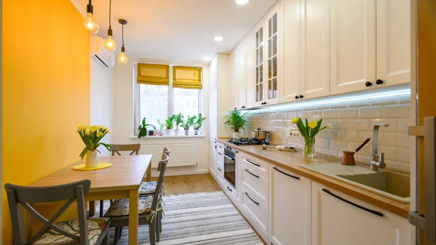 Cozy yellow-themed kitchen with flowers.