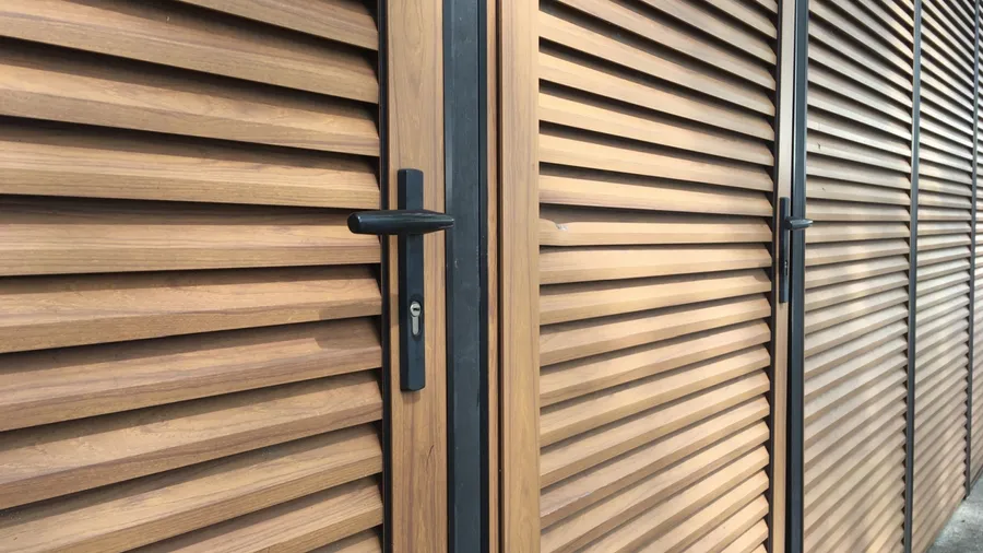 Matte black door knob on a wooden door.