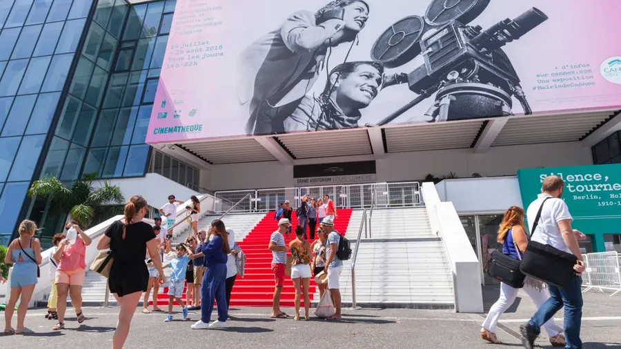 Cannes, France - August 14, 2018: Tourists are in front of Palais des Festivals et des Congres, a convention center, the venue for the Cannes Film Festival, the Cannes Lions International Festival