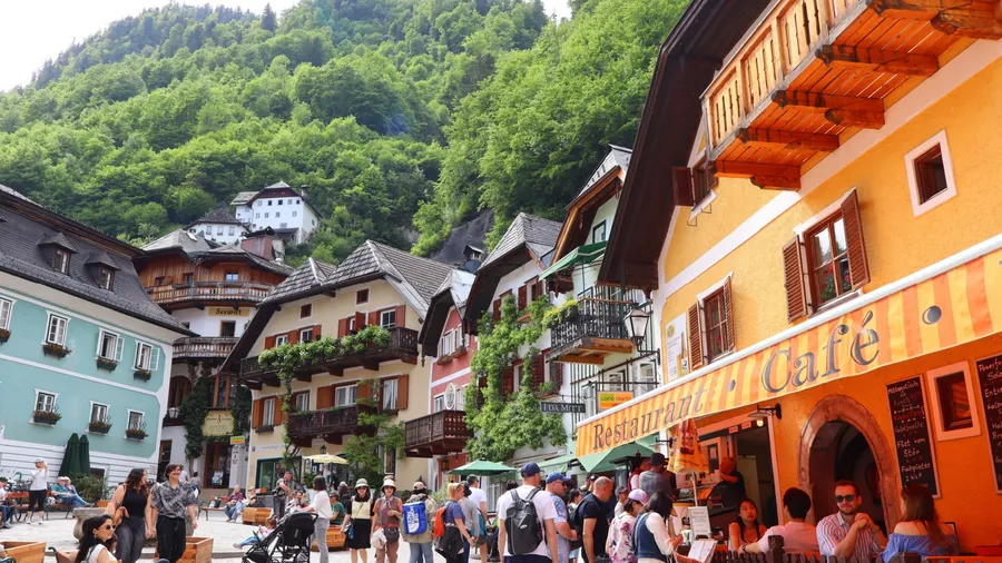 Hallstatt, Austria - May 03 2025: Amazing view of main square in Hallstatt, horizontal, people enjoying