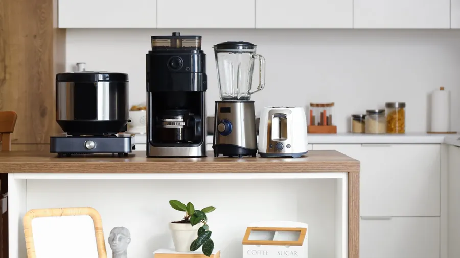 A modern kitchen with coffee-making appliances on the counter.