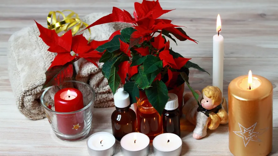 Essential oils, candles, and towels on a table.