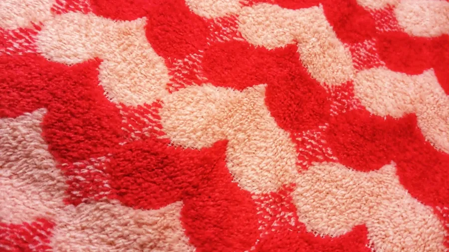 A towel with red and white heart patterns.