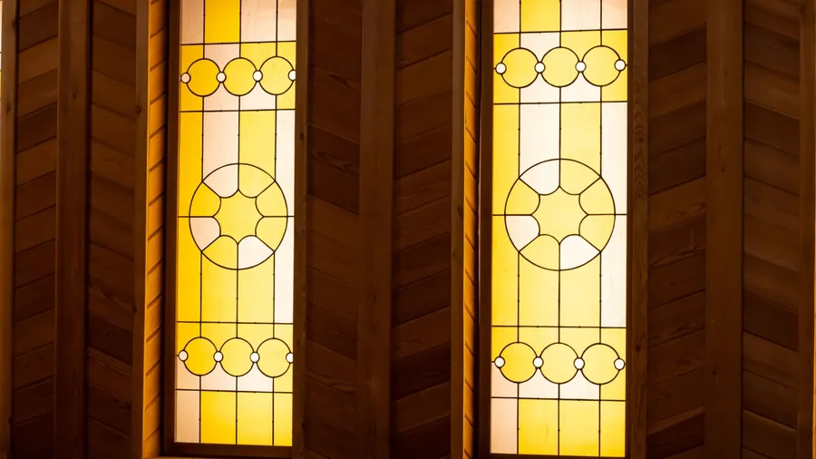 Bright interior with stained glass windows and wooden accents.