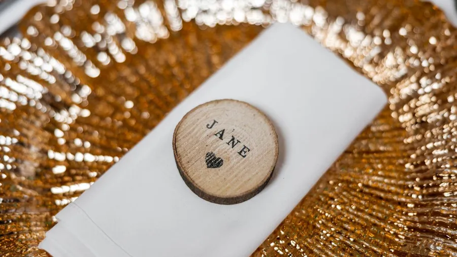 Gold-plated dinnerware with personalized wooden name tag.