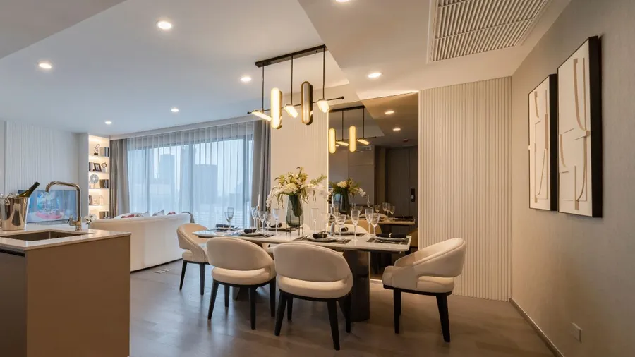 A modern dining space with layered textures, blending soft upholstery, sleek surfaces, and warm wood for a balanced, elegant look.