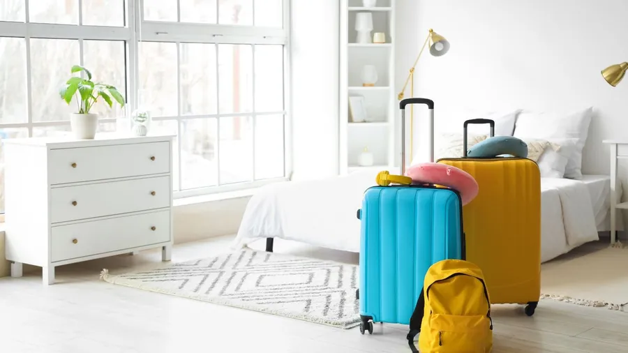 Suitcases with travel accessories in hotel room 2452964633