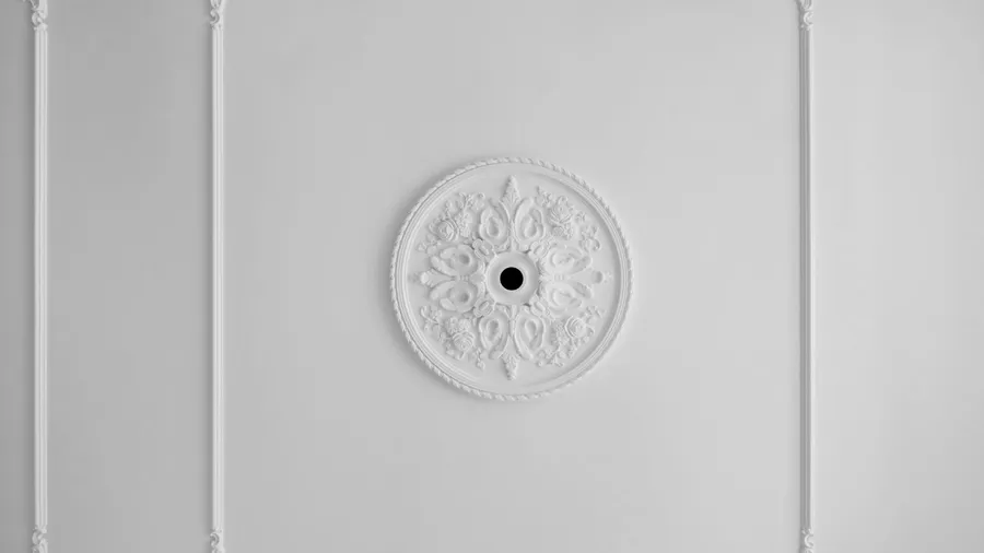 Detail of corner and ceiling cornice with intricate crown molding.