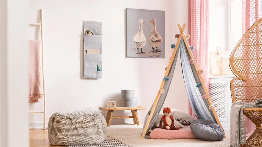A kid's room interior with a pouf, canopy, pillows, rug, and a stuff toy.
