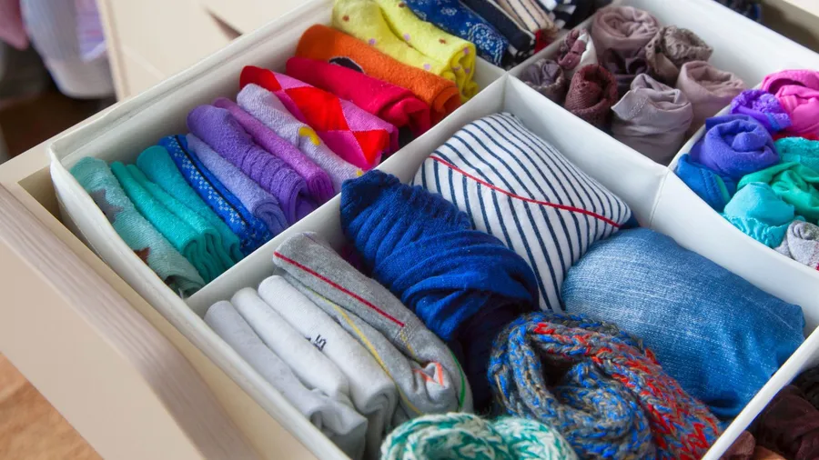 Different clothes organized in a drawer using drawer organizer.