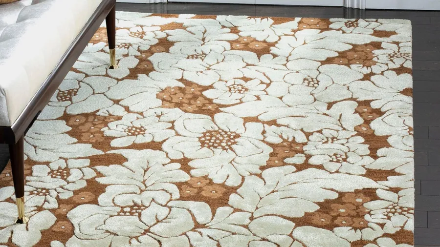A nature-inspired rug with a floral pattern in earthy tones on a dark wooden floor.