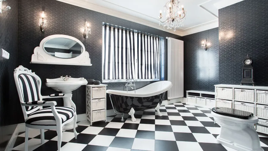 A black and white themed bathroom with a freestanding tub and elegant decor.