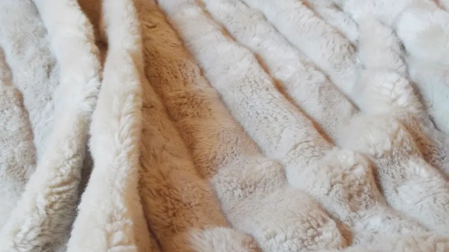 A soft and cozy faux fur throw blanket.