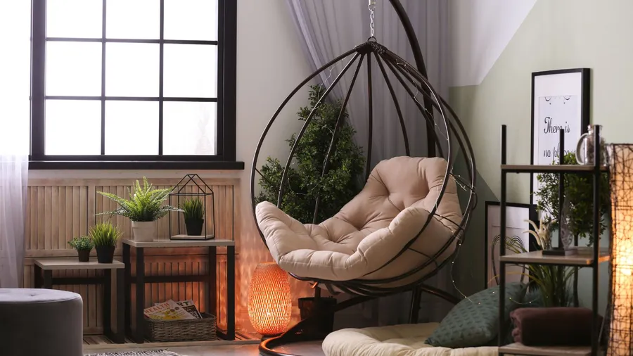 A cozy living room with a hanging chair, plants, and soft lighting.