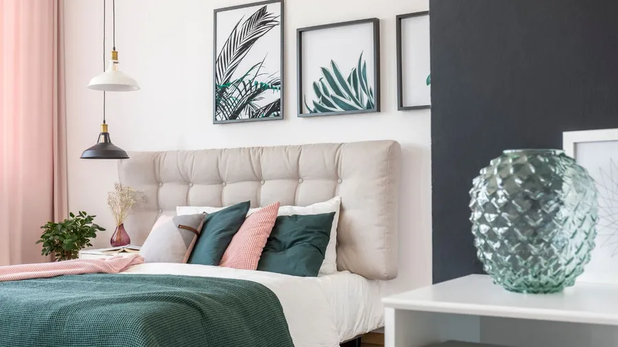 Stylish bedroom with a framed artwork and pink curtains.