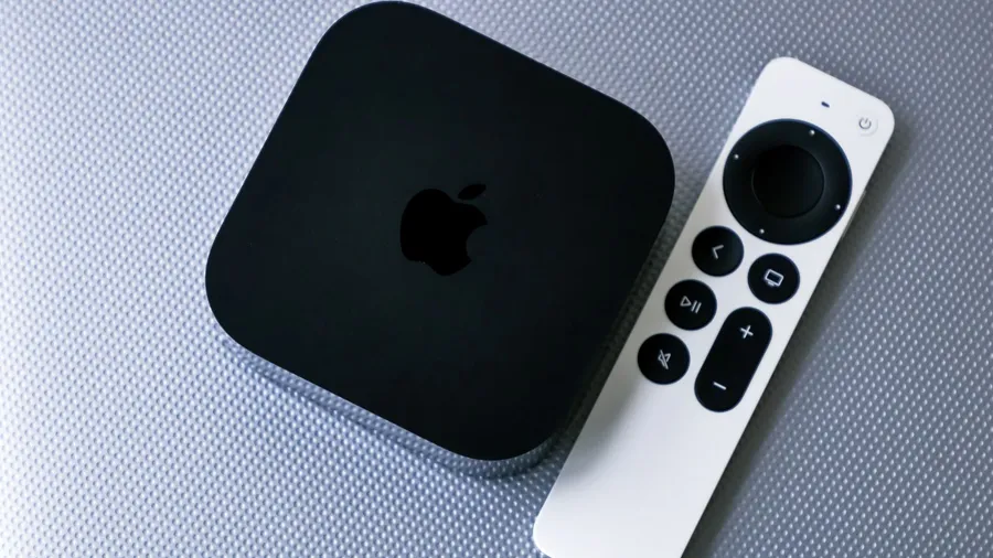 An Apple TV streaming device on a gray background.