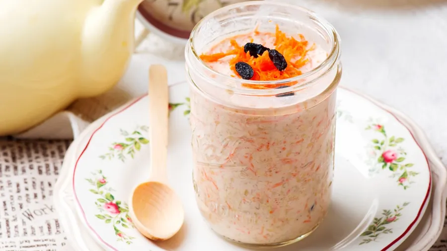Carrot cake in a mason jar served on a plate
