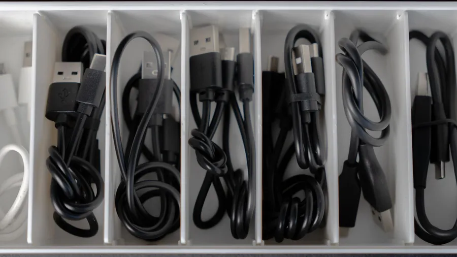 Neatly organized cables of different types in an organizer.