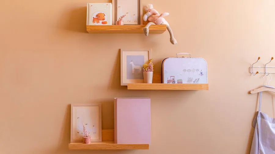 Wooden picture ledges with photo frames and decor pieces.