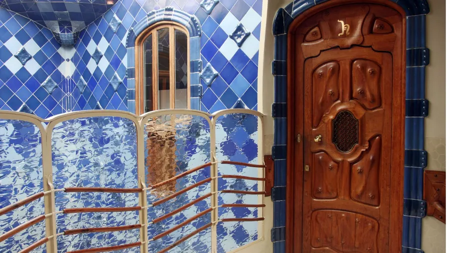 Detail of door present in casa batllo and blue tiles.