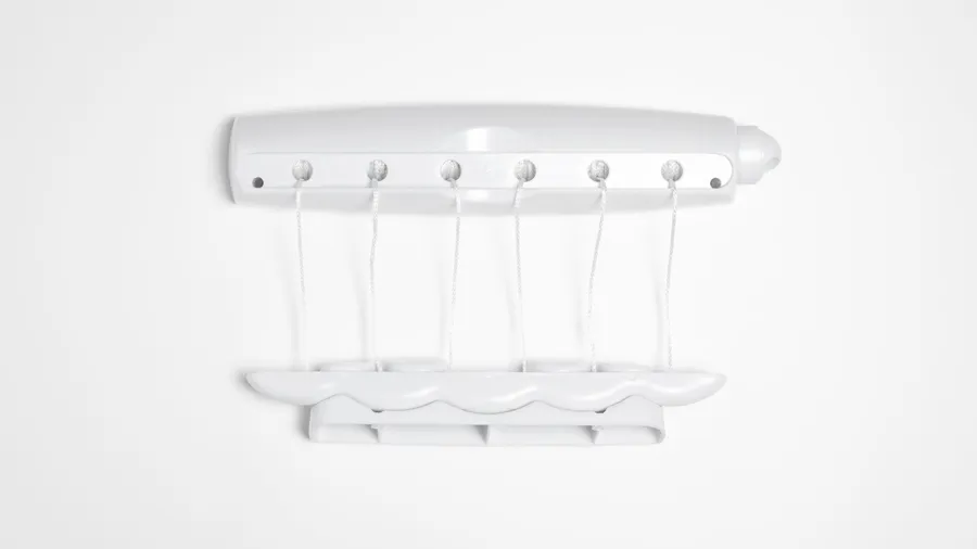 A retractable clothesline on a white wall.