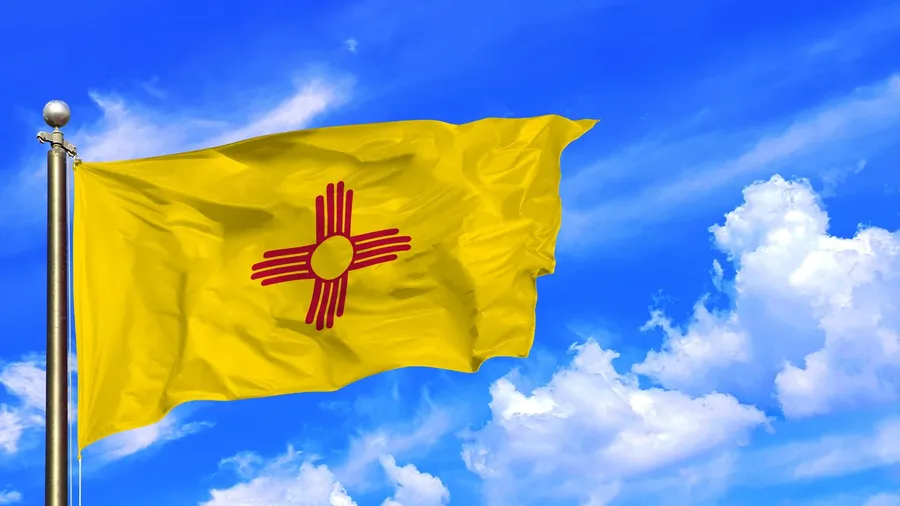 The New Mexico’s Zia Sun Symbol Flag Waving in the Clear Sky