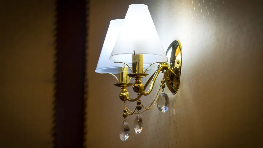 sconces hanging on the wall upholstered in fabric.