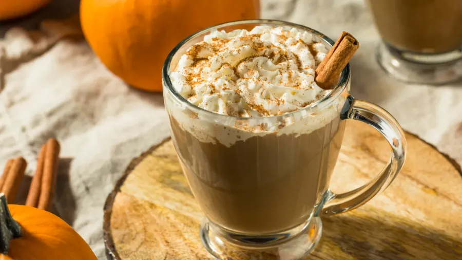 Warm seasonal pumpkin spice latte with whipped cream.