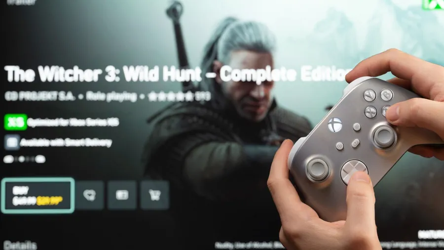 A person holding Xbox controller and playing game.