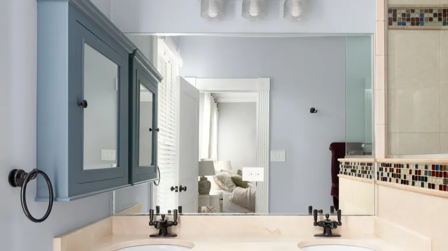 a bathroom with blue cabinet and medicine cabinet a marble