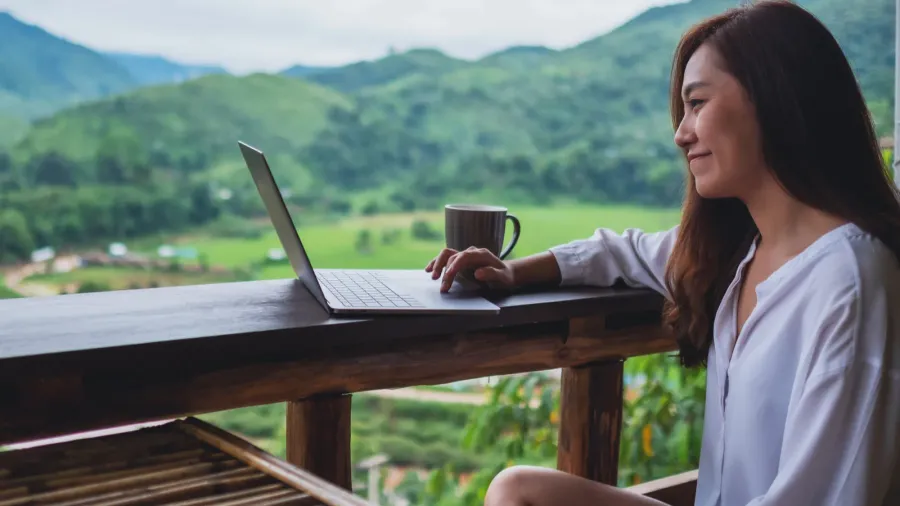 a beautiful asian woman working and typing on laptop computer