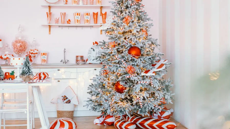 a beautifully decorated christmas tree fills the corner of a