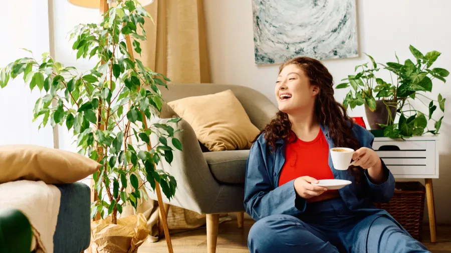 a cheerful young woman with curly hair relaxes at home
