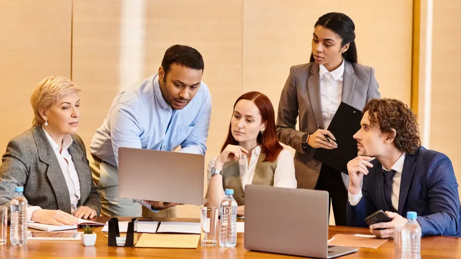 a diverse group of business people collaborate at a conference