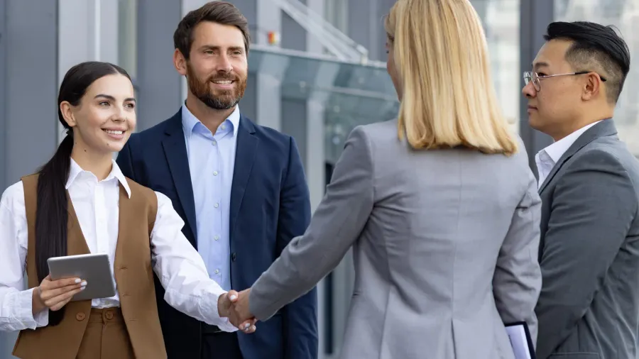 a diverse group of business professionals engaging in a handshake