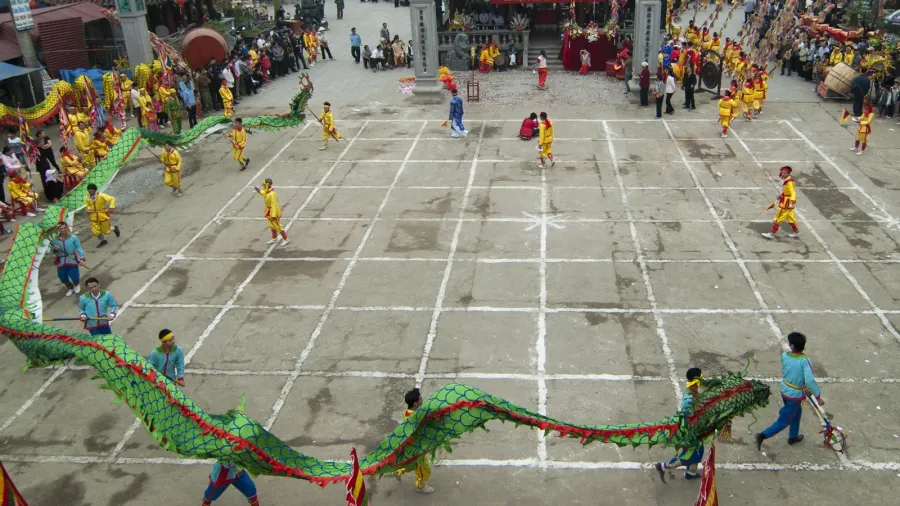 a group of unidentified dancer with their colorful dragon on