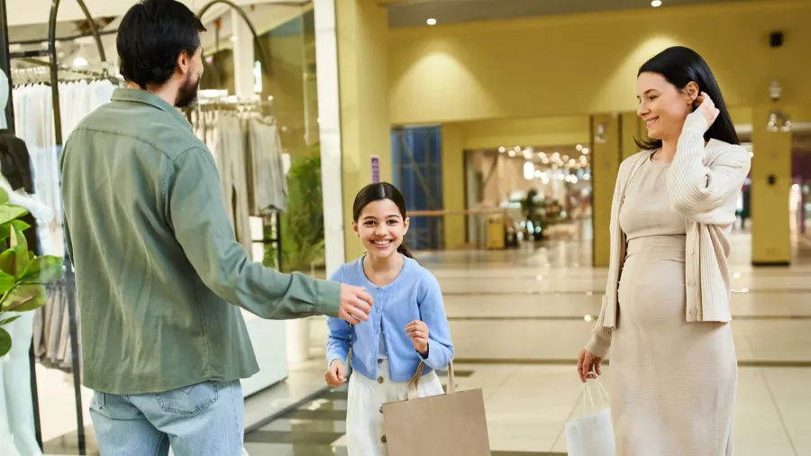 a man and woman shop with their daughter enjoying a